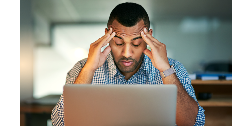 Microsoft Dynamics 365 ERP with KRA eTIMS System Integration: stressed man holding his head infront of a computer
