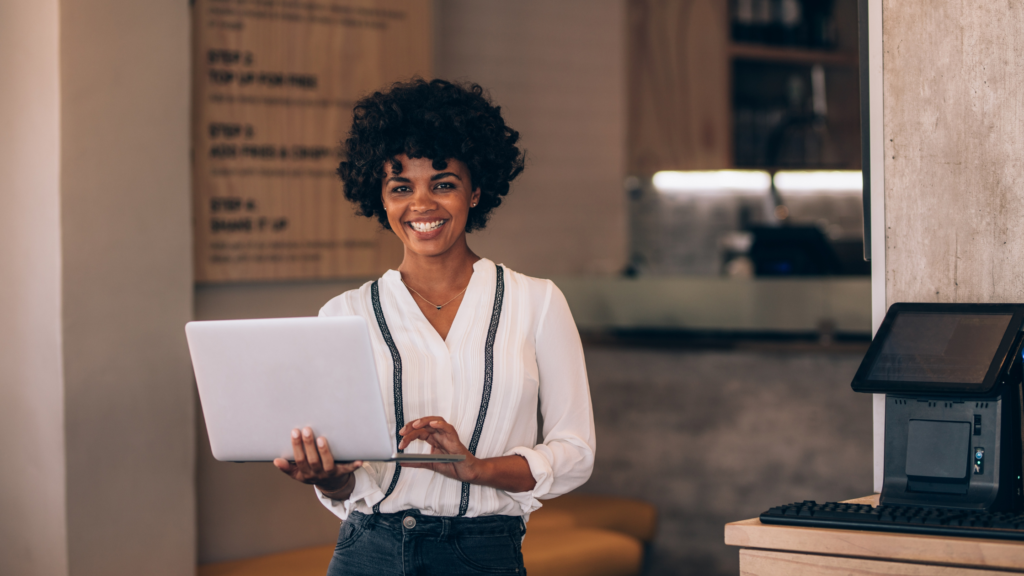 KRA eTIMS Compliant POS in Kenya: Black business woman holding a laptop